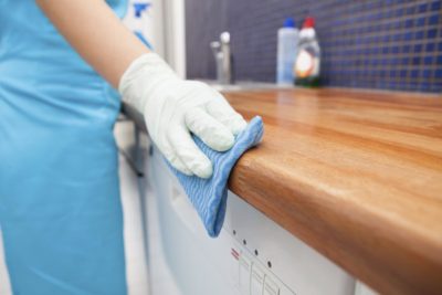 Cleaner polishing a kitchen counter in a Parker CO home.